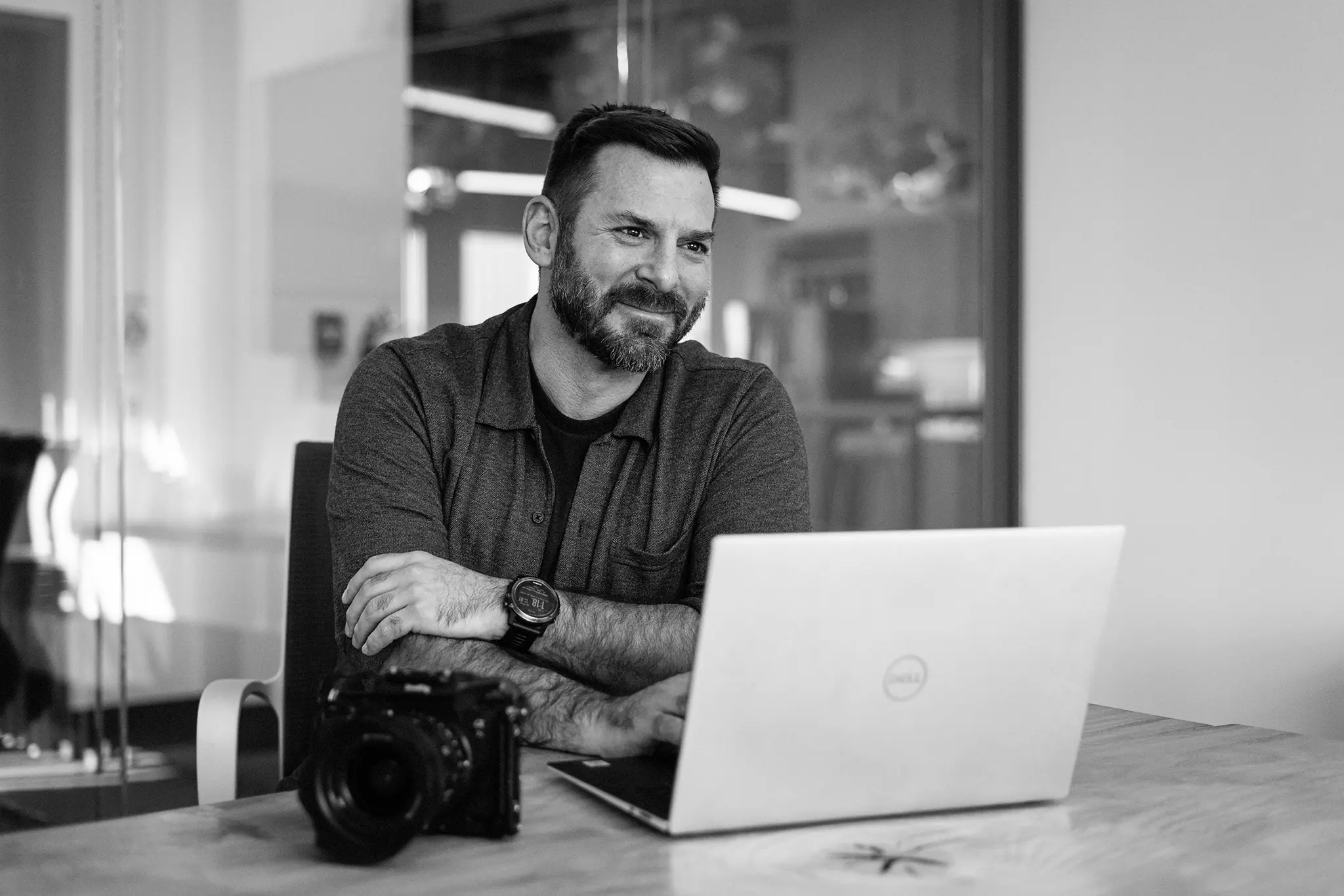 Michael Bonocore in his Boise workspace, mid-call, laptop open beside him, natural window light.
